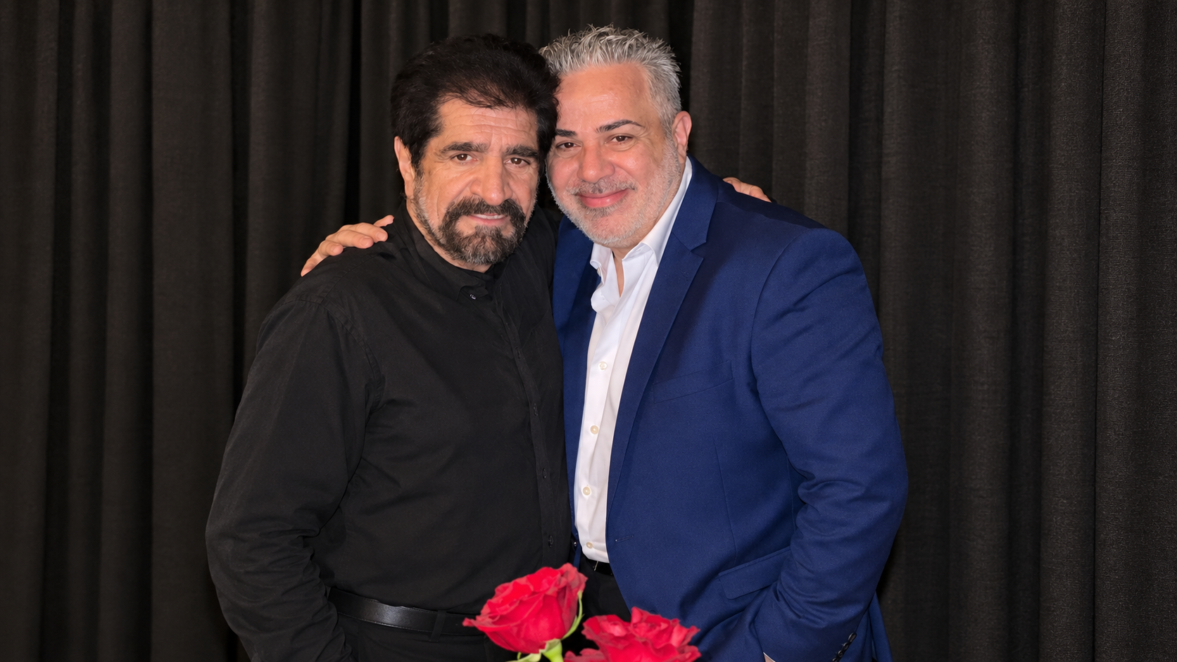 Harout Pamboukjian and Sako Ghazarossian together, with red roses in the foreground; AI-enhanced landscape version of the original photograph.